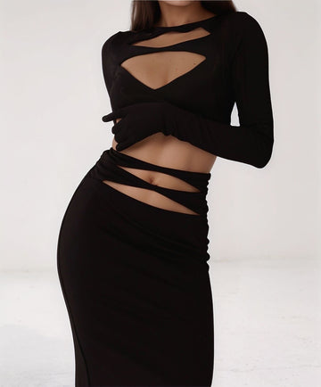 Front view of Chic Temptress black cut-out gown with long sleeves and sculpted bodycon fit