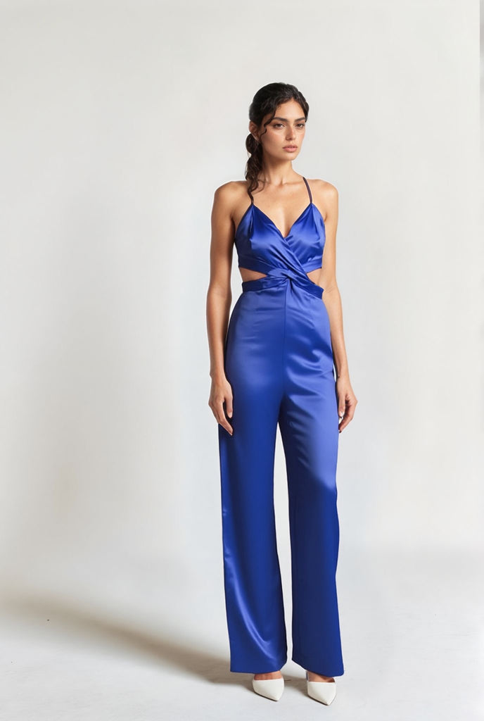 Blue jumpsuit with side cut-out and spaghetti straps, model facing forward in full-length pose offered by Gamine
