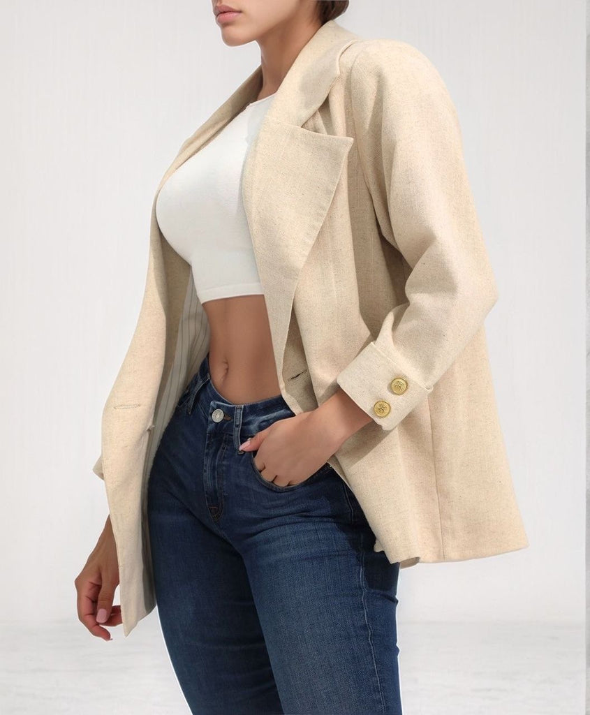 Side view of the Dream Drifter jacket showcasing its draped sleeves and relaxed beige fit, styled over the white Lavi Top.