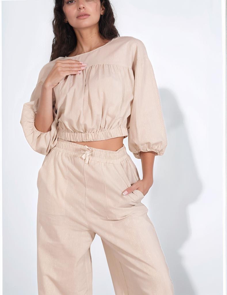 Close-up side view of beige Featherlight Duo Coords highlighting ruffled top and pocket detail
