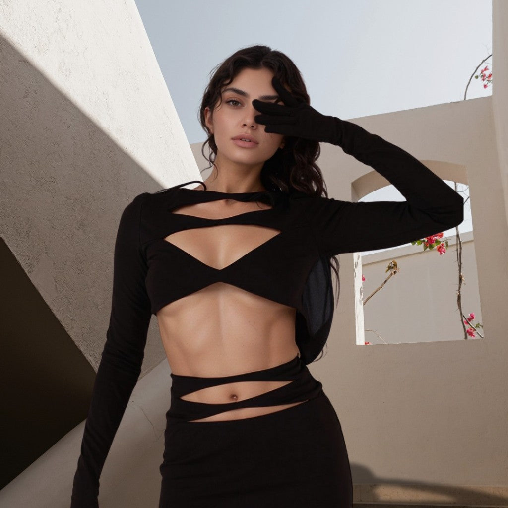 Gamine woman wearing a bold black cut-out outfit from the Chic Temptress collection in an architectural outdoor scene