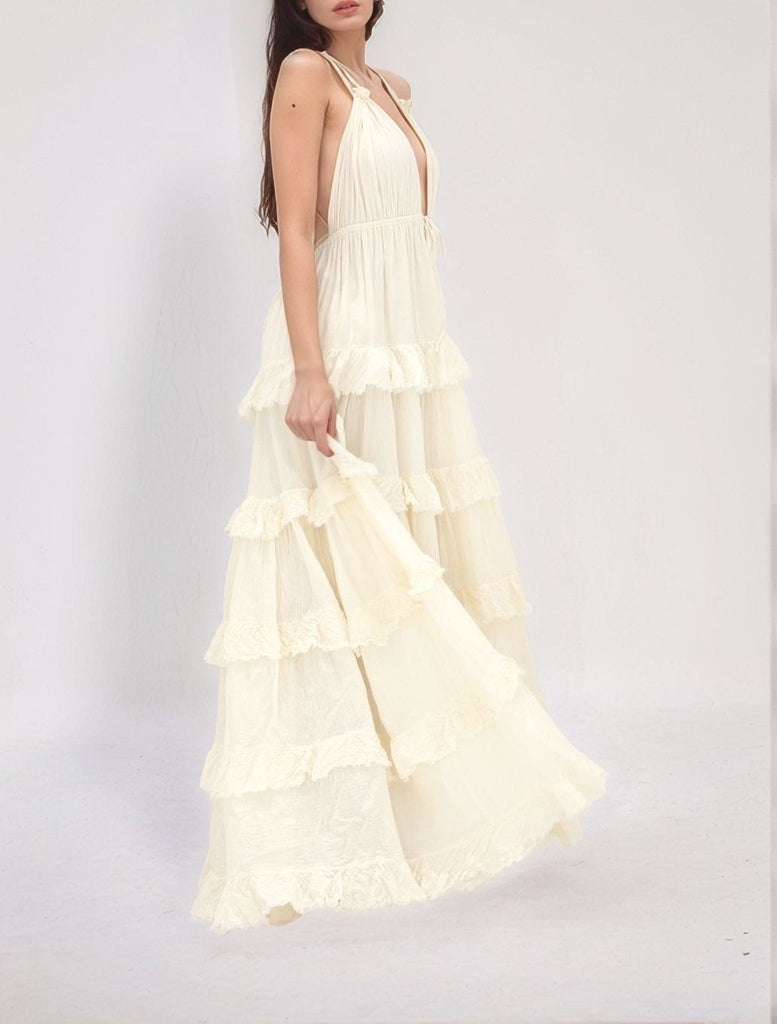 Mystic Ruffle Maxi dress – side view of beige maxi with layered ruffle tiers and deep V‑neckline