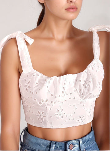Close‑up front view of the Opal Sheen Crop top in white, highlighting the bow‑tied shoulder straps on a model