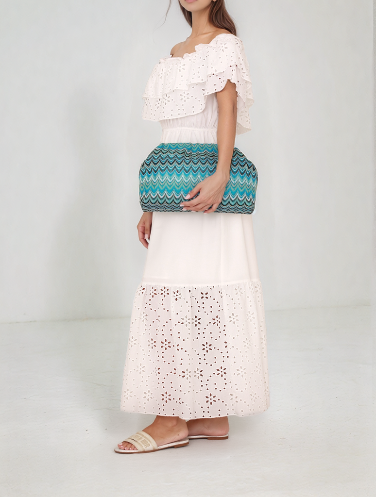 Side view of white Rustic Elegance Dress holding teal Island Paradise Clutch from Gamine Lebanon