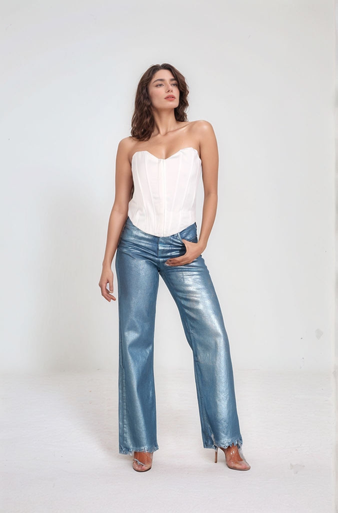 Side view of the Snowflake Corset top showcasing its contour fit and glossy white finish, styled on a model wearing Metallic Denim