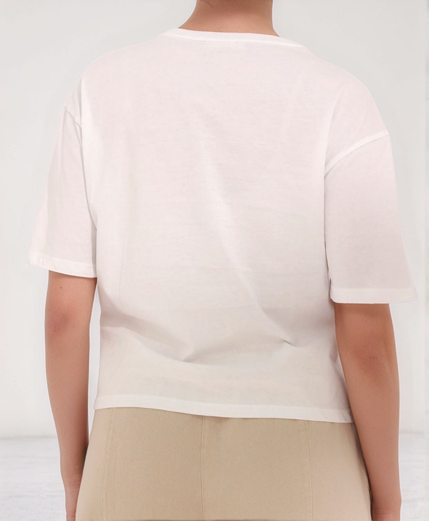 Gamine Summer Essence top – back view of white cotton crew-neck tee styled with beige B Trouser pants