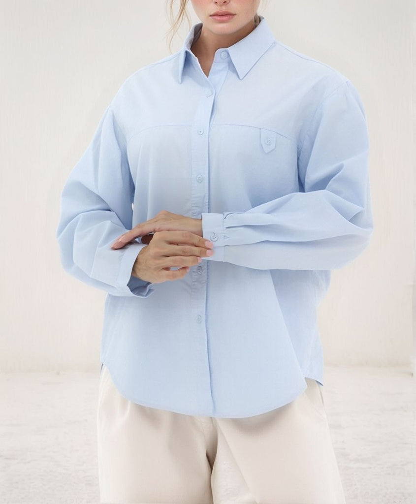Urban Tranquility Shirt – relaxed front view of light‑blue shirt showing chest pocket and cuffs